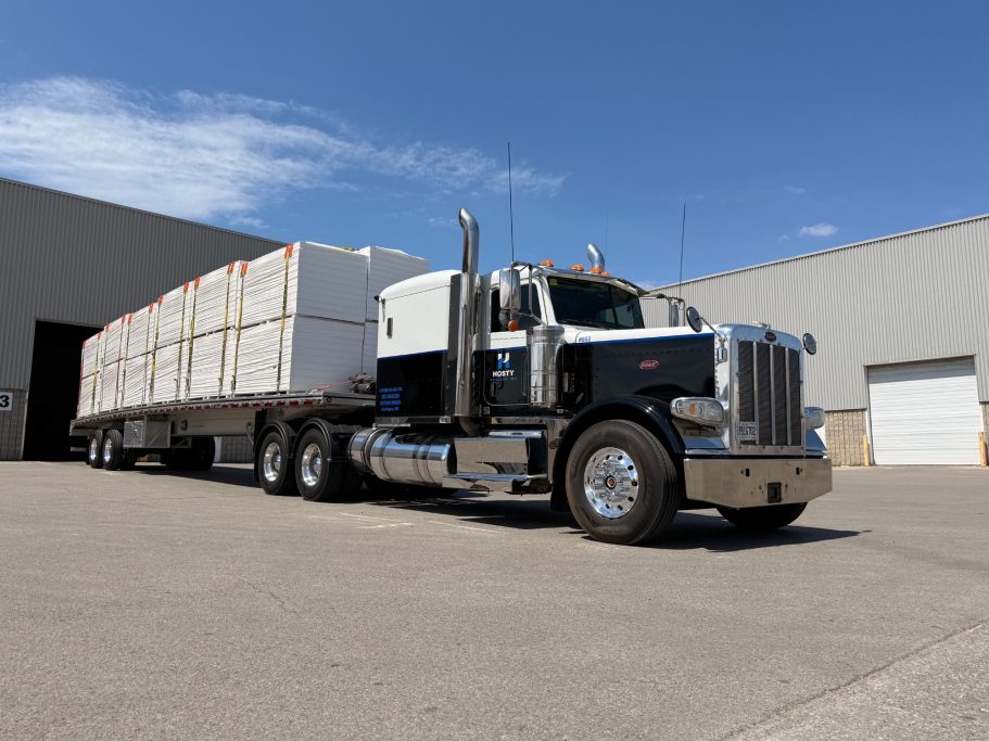 Commercial flatbed transport haul showing legal load securement and strapping.